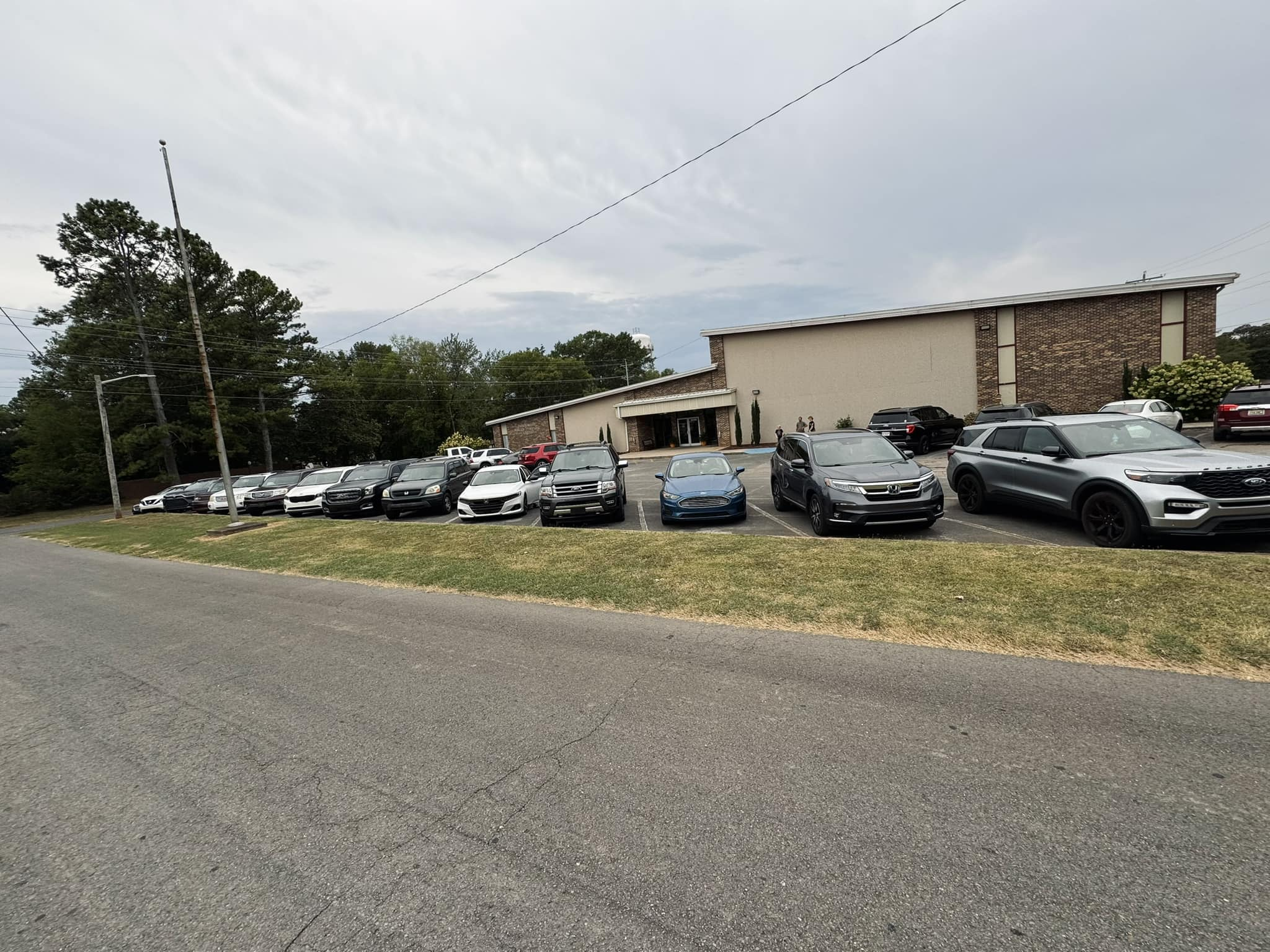 A row of parked cars in front of a building
